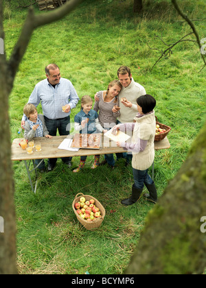 People eating applecake with basket Stock Photo