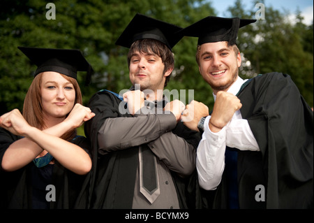 Three Ex students wearing gown and mortar board on Graduation day Aberystwyth University Wales UK Stock Photo