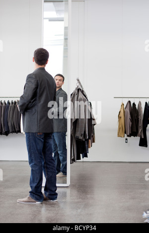 man looking at himself in mirror Stock Photo