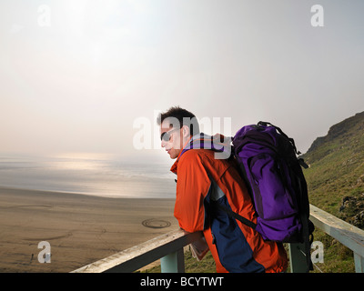 man hiking on cliff edge Stock Photo