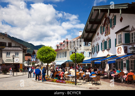 Oberammergau town centre street scene with people at pavement cafes, Bavaria, Germany in summer Stock Photo