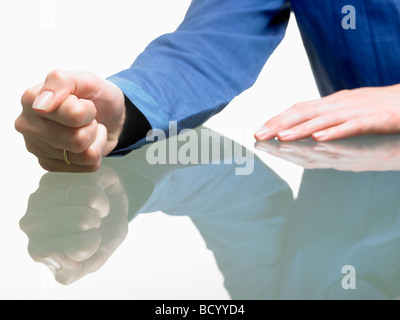 Fist of a woman on table Stock Photo