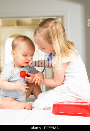 Brother and sister playing doctor Stock Photo