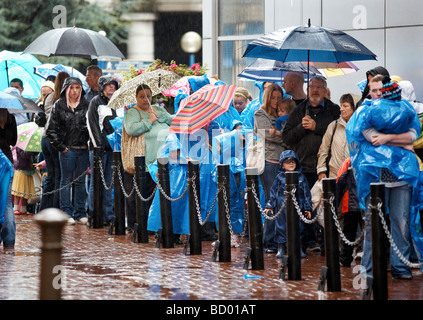 Visitors to the Sealife Centre in Birmingham, UK, queue outside in the rain. Stock Photo