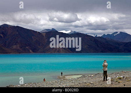 Tourists contemplating Pangong Lake. Ladakh. India Stock Photo