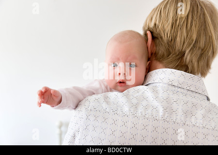 father carrying baby on shoulder Stock Photo