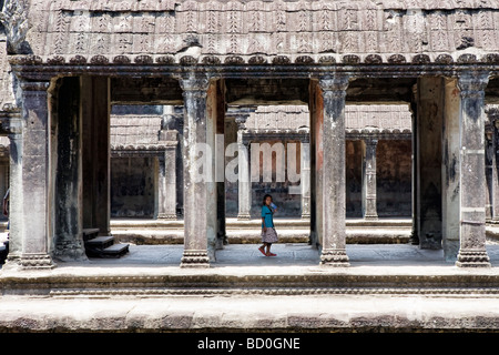 Young child inside the temple complex at Angkor Wat in Cambodia Stock Photo