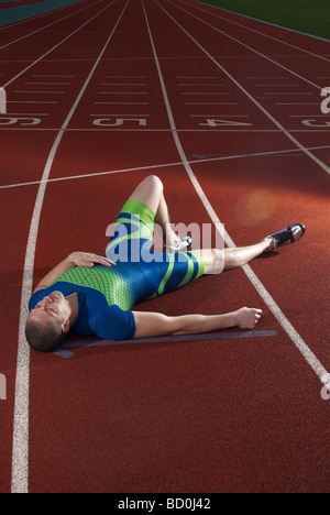 athlete lying on track Stock Photo