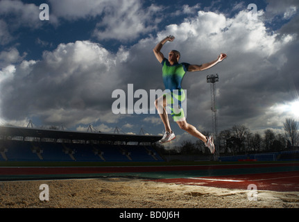 athlete doing long jump Stock Photo