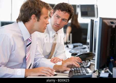 Colleagues Working Together At Computer Stock Photo