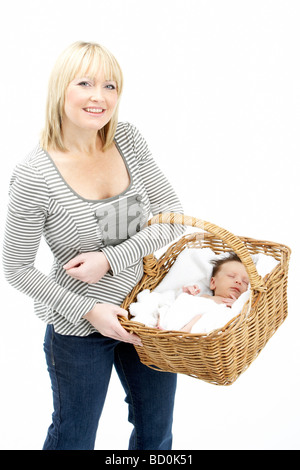 Newborn Baby Held In Basket By Mother Stock Photo