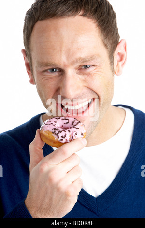 Man Taking Bite Of Doughnut Stock Photo