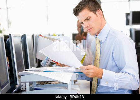 Stock Trader Looking Though Paperwork Stock Photo