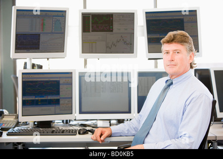 Portrait Of Stock Trader In Front Of Computer Monitors Stock Photo