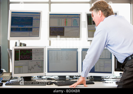 Stock Trader Examining Computer Monitors Stock Photo