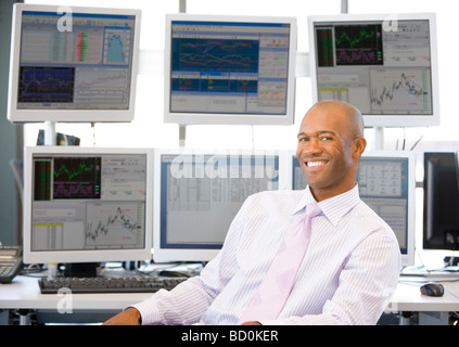 Portrait Of Stock Trader In Front Of Computer Monitors Stock Photo