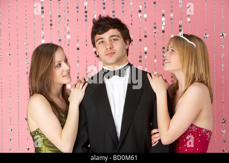 Two Teenage Girls Looking At Boy Stock Photo