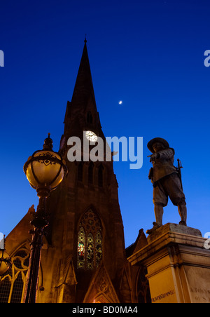 Statue of Oliver Cromwell in twilight juxtaposed with a street lamp and The Free Church in St Ives Stock Photo