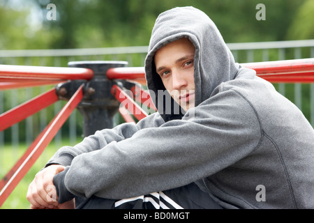 Young Man Sitting In Playground Stock Photo