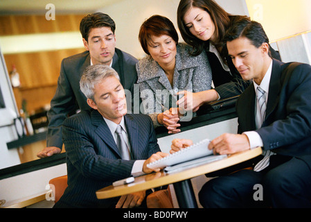 Team of associates collaborating in office Stock Photo