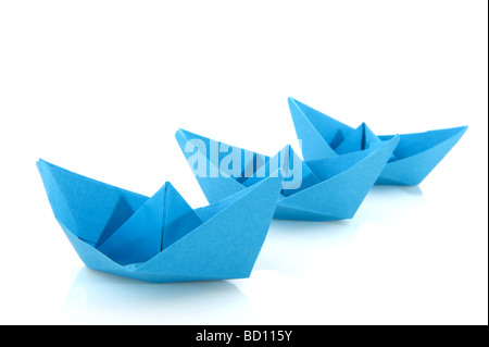 Paper boats in blue isolated over white