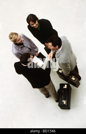 Business associates standing together, two men shaking hands, high angle view Stock Photo
