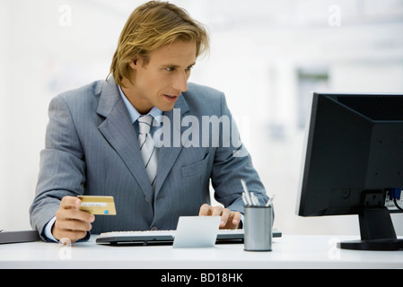 Businessman making online purchase with credit card Stock Photo