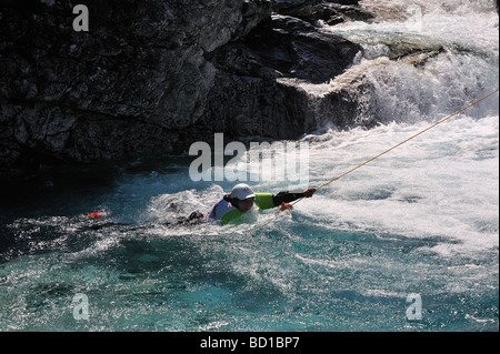 Woman rescued in a river after she failed in a kayaking competition Stock Photo