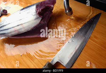 Cut bonito and kitchen knife on cutting board Stock Photo