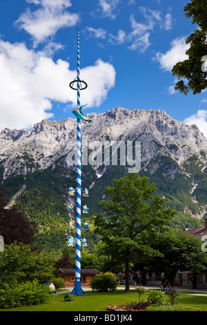 A traditional maypole with trade symbols in Mittenwald, Bavaria, Germany, Europe Stock Photo
