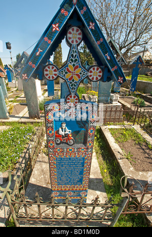 Carved cross marking grave of disabled man in the Merry Cemetery in Sapanta Stock Photo