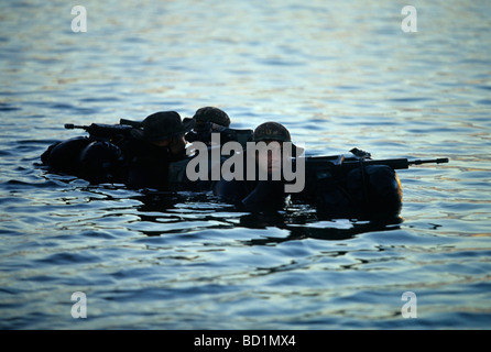 Armed Soldiers of the German special forces 'Kampfschwimmerkompanie' waiting on the surface of the sea for helicopter pickup, E Stock Photo