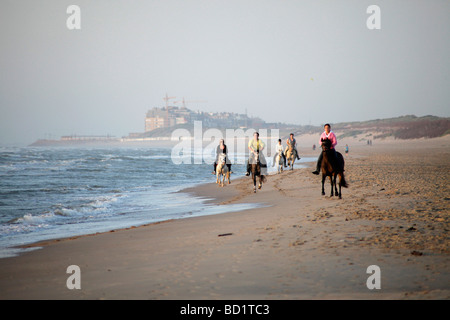 group of youth horse riding at the baltic beach in De Haan Belgium Stock Photo