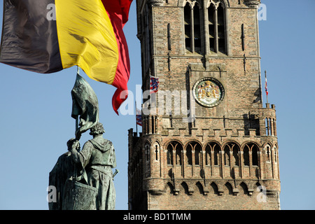 flag and the statue of the Bruges folk heroes Jan Breydel and Pieter de Coninck on the market square Grote Markt  bruges Stock Photo