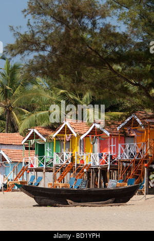 Cocohut beach holiday bungalows on stilts Agonda beach Goa India Stock Photo