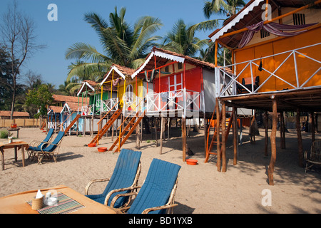 Cocohuts beach holiday bungalows on stilts Agonda beach Goa India Stock Photo