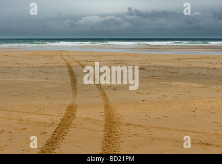 Tyre tracks in the sand at Gwithian Towans beach in Cornwall. Stock Photo