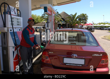 Garage attendant filling car with petrol, N2,Riversonderend, Overberg, Western Cape, South Africa, Africa. Stock Photo