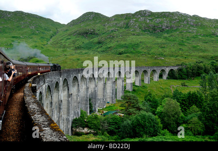 The Jacobite Steam train crosses the Glenfinnan Viaduct during the journey from Fort William to Mallaig, Scotland. Stock Photo
