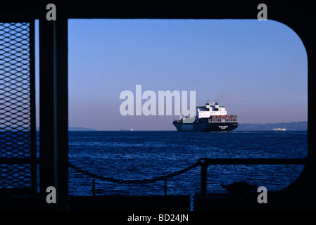 Tanker in Puget Sound viewed through a passenger ferries window during the day with other ferry boats Port of Seattle Stock Photo