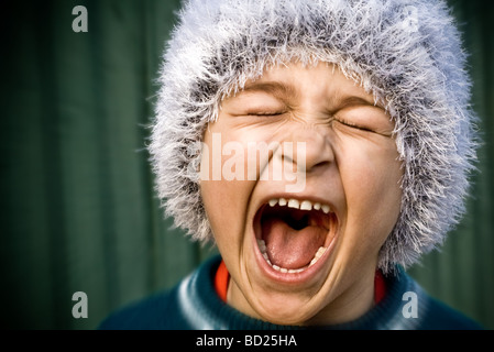Close up of portrait of crazy kid screaming loudly Stock Photo