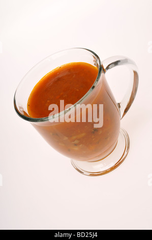 Mug of Manhattan clam chowder soup made with a tomato base on white background cut out. Stock Photo