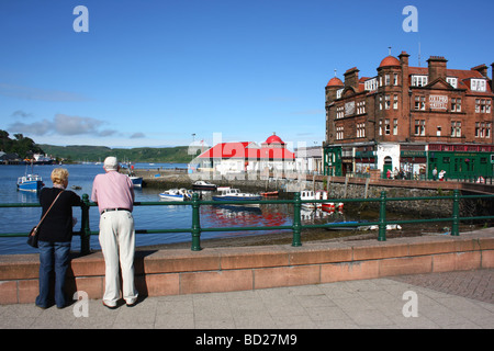 Middle-aged couple taking in the view at the North pier, Oban harbour, Argyll and Bute, West coast of Scotland Stock Photo