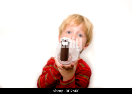 Boy using asthma inhaler with spacer device Stock Photo