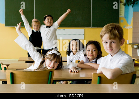 Happy children in classroom Stock Photo