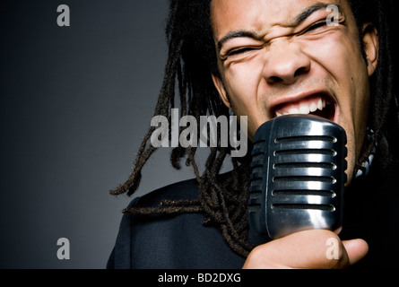 man shouting into mic close-up Stock Photo