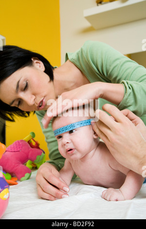 Doctor measuring baby head circumference. Pediatrician place