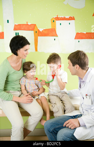 mother with children visiting doctor Stock Photo