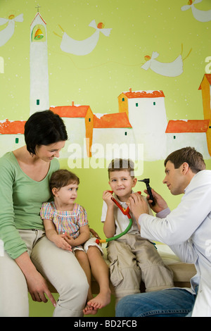 mother with children visiting doctor Stock Photo