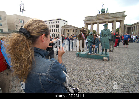 Tourists pose for photos outside Brandenburg Gate Brandenburger Tor in Berlin Stock Photo